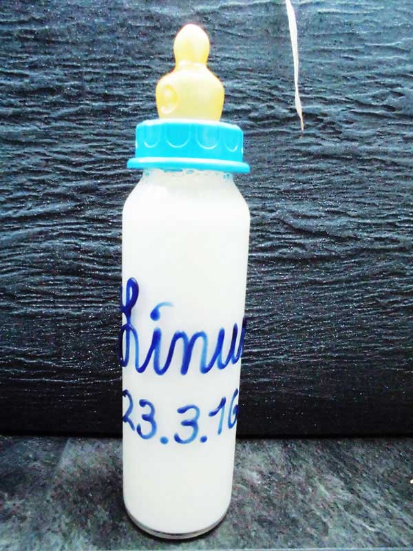 Babyflasche mit Namen mit Milch gefüllt in blauer Schrift